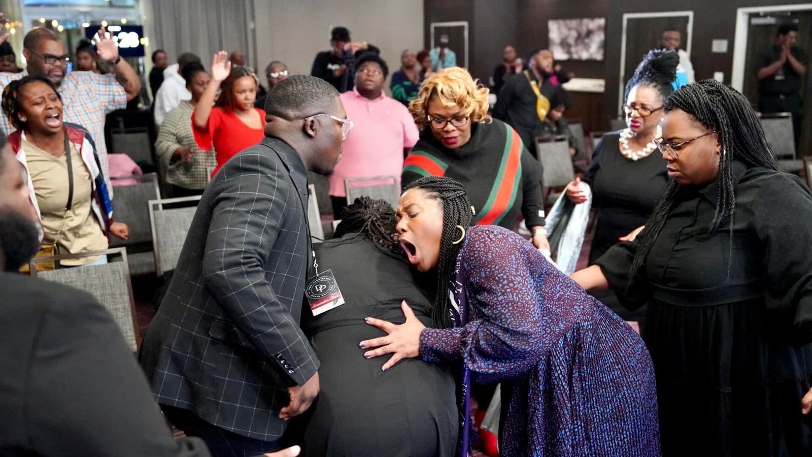 Ministry at a Dwelling Place conference, people praying over one another